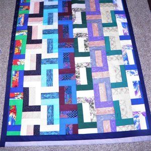 MULTI-COLORED GEOMETRIC-STYLE QUILT